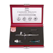 Iwata Custom Micron CM-B airbrush kit with precision components in a red metal case for flawless spraying and superior atomization.