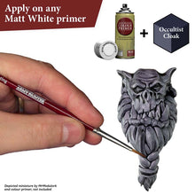 The Army Painter Speedpaint Occultist Cloak showing hand brush painting a detailed miniature accessory with greyish green shading.