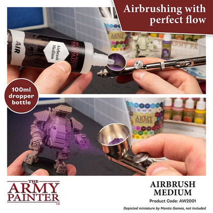 The Army Painter Airbrush Medium being poured into an airbrush for smooth painting flow and miniature detailing.