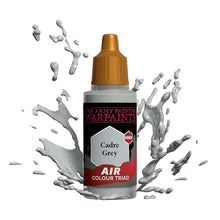 The Army Painter Air Cadre Grey bottle with grey paint splashes showcasing high-quality air color triad paint.